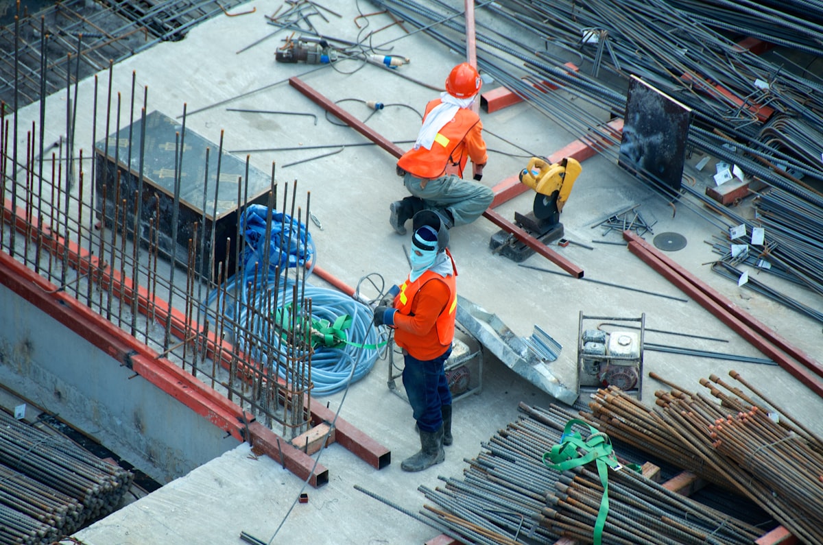 Construction workers in hi-vis and hard hats on a UK building site