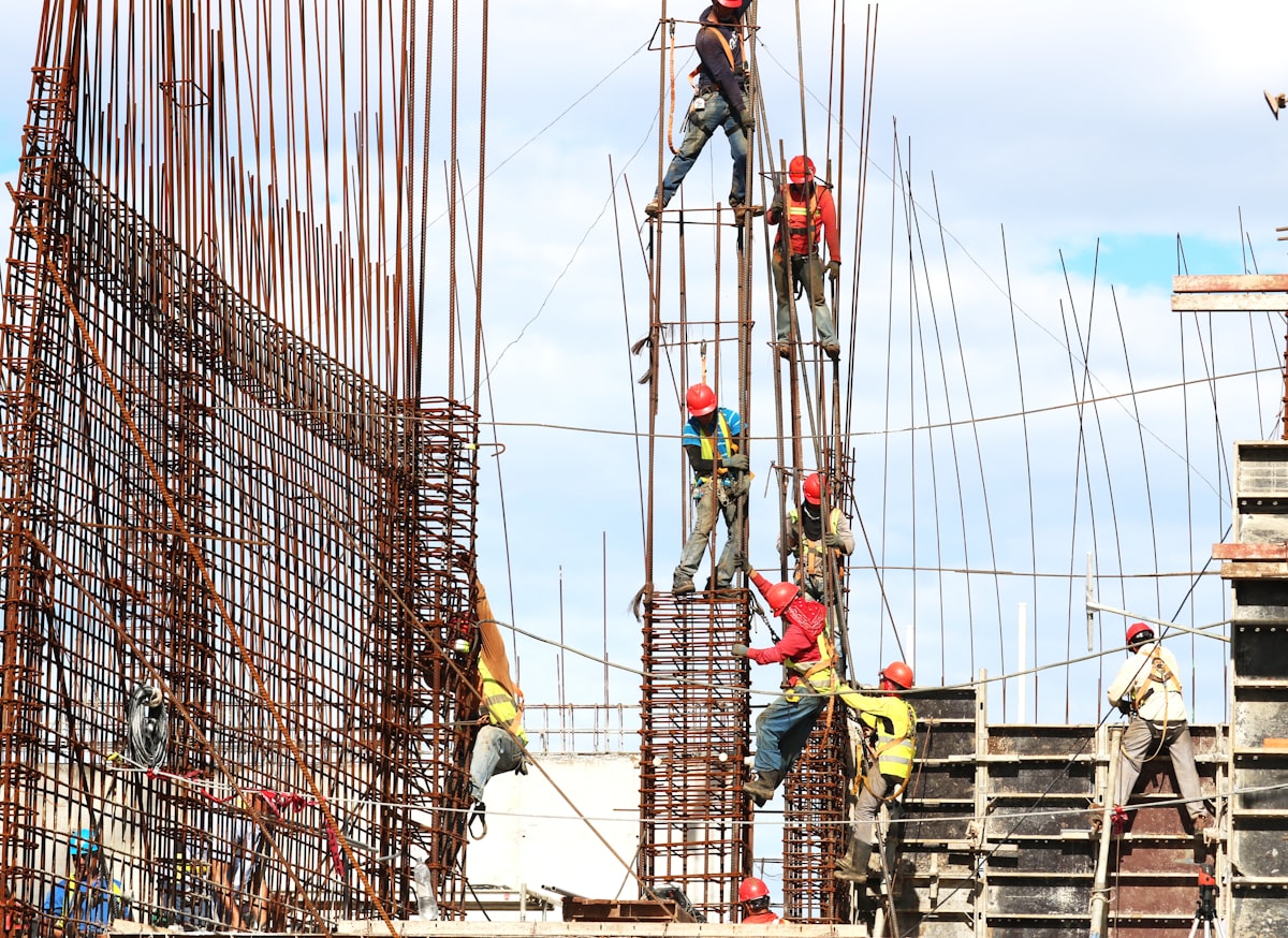 Steel fixers working on a reinforced concrete structure on a UK construction site